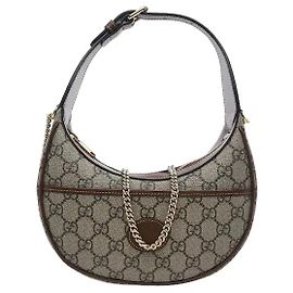 Gucci Un modello dotato sia di una sensibilità vintage che di una praticità moderna. Il materiale in tela altamente resistente è impreziosito da rifiniture in pelle marrone per un'atmosfera classica, e il G Interlocking ovale