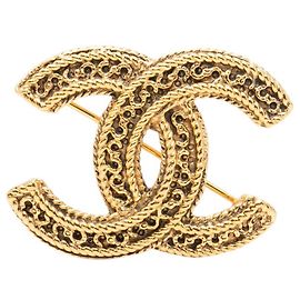 Broche Chanel Gold CC chapado en oro filigrana