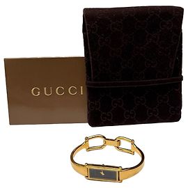 Reloj pulsera Vintage Gucci tono dorado y negro c. finales de los 80 – principios de los 90
