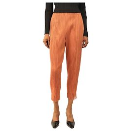 Pleats Please Pantalones plisados naranja tostado con dobladillo de flecos - size S