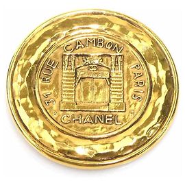 Spilla Chanel in metallo dorato