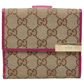 Cartera bi-fold Gucci GG Canvas con placa de metal