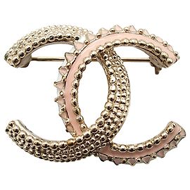 Spilla Chanel CC laccata placcata oro dorato