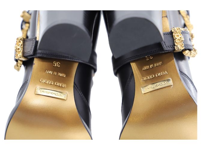Botas de cano alto Dolce & Gabbana com detalhe de fivela dourada em couro preto - vista 2