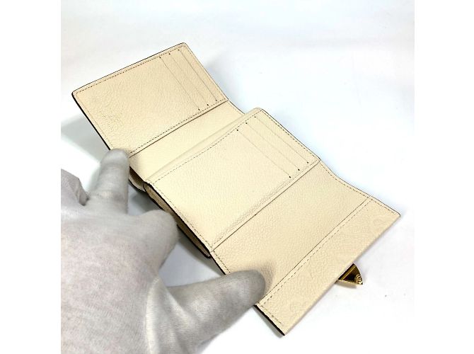 Cartera Metis Trifold Monogram Empreinte Louis Vuitton Beige - vista 9