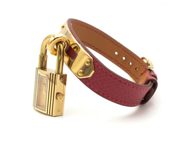 Hermès Kelly Uhr.- Einzelnes rotes Lederarmband mit Hermès-Unterschrift. Golden - Ansicht 2