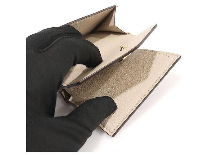 Louis Vuitton Cartera mini de piel de ternera beige greige con cierre dorado Castaño - vista 6
