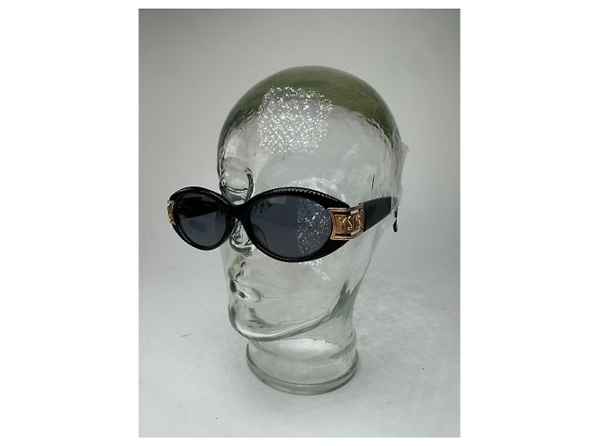 Lunettes de soleil vintage Yves Saint Laurent noires et dorées avec logo YSL - vue 10