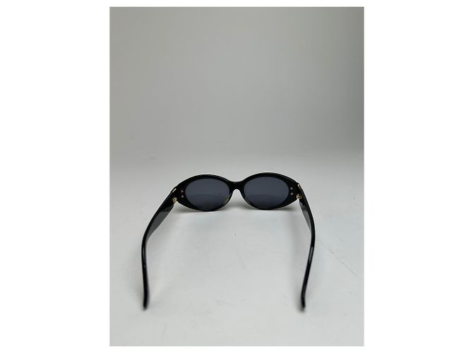 Lunettes de soleil vintage Yves Saint Laurent noires et dorées avec logo YSL - vue 4