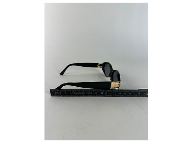 Lunettes de soleil vintage Yves Saint Laurent noires et dorées avec logo YSL - vue 8