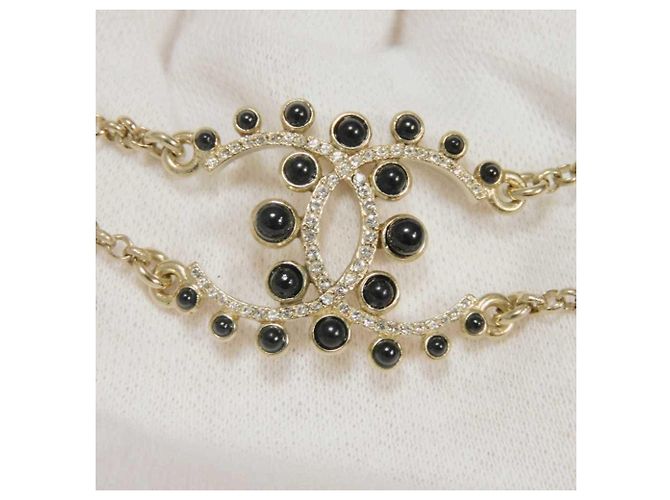 Pulsera Charm Chanel Negro Dorado Crudo - vista 3