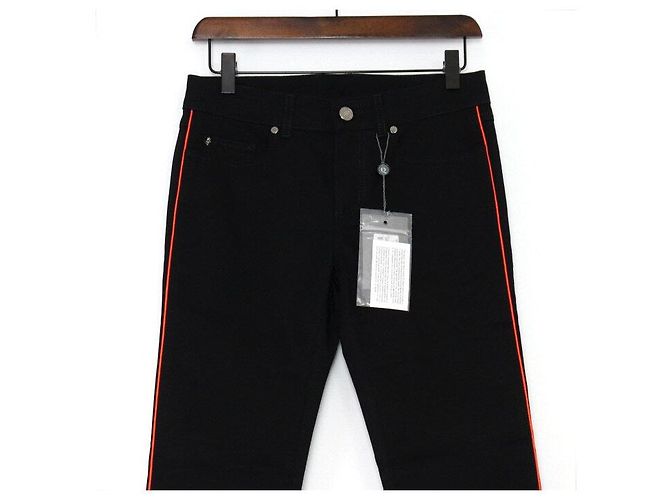 Alexander Mcqueen Vaqueros de denim negros para mujer con raya lateral naranja - vista 2