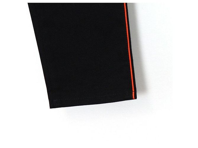 Alexander Mcqueen Vaqueros de denim negros para mujer con raya lateral naranja - vista 3