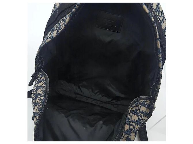 Christian Dior A travel backpack featuring Dior's iconic Oblique jacquard pattern. Made from waterproof technical canvas material, it offers a lighter weight than leather along with scratch-resistant durability. A - view 6