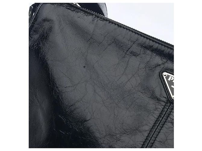 A leather shoulder bag showcasing smooth leather material and Prada's signature triangle logo. Its compact yet practical interior storage structure makes it easy to separately store belongings, and - view 4