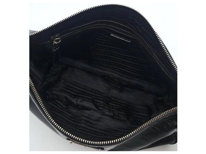 A leather shoulder bag showcasing smooth leather material and Prada's signature triangle logo. Its compact yet practical interior storage structure makes it easy to separately store belongings, and - view 5
