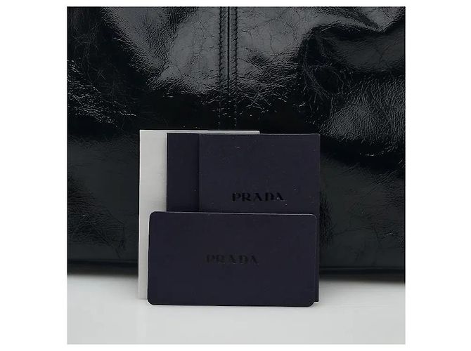 A leather shoulder bag showcasing smooth leather material and Prada's signature triangle logo. Its compact yet practical interior storage structure makes it easy to separately store belongings, and - view 7