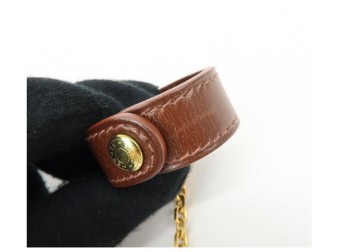 Hermès HERMES Portaguanti Nomad in pelle e metallo Charm Brown - vista 12
