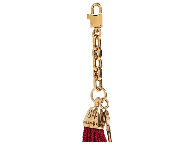 Charm per borsa Dolce & Gabbana oro con chiave e nappa rossa - vista 3