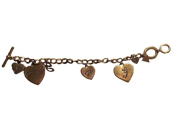 Pulsera Guess con dijes dorada de metal Dorado