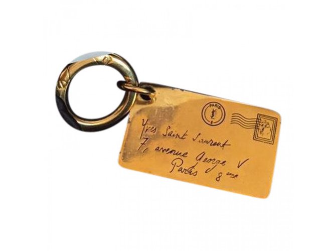 Yves Saint Laurent Amuleto bolsa Dorado Metal  ref.40031