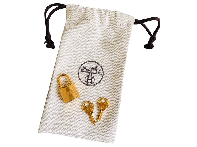 Hermès Candado de oro Hermes para Birkin gold kelly bags, neuf 2 Llaves y pochon! Dorado Acero  ref.133973