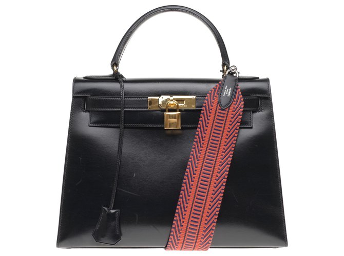 Superb Hermès Kelly saddler 32cm black box leather, shoulder strap in red and black strap, gold plated metal trim, In very beautiful condition!  ref.200768