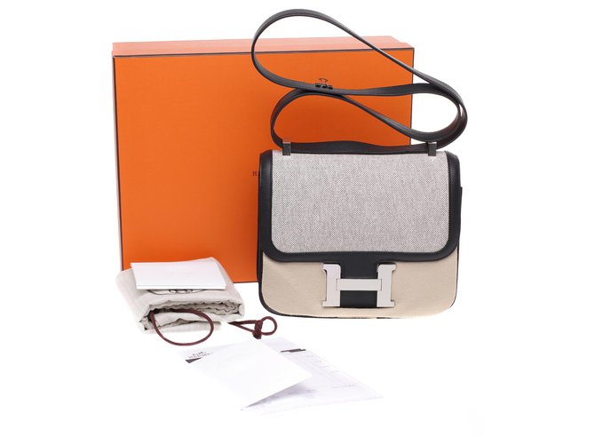 Limited Edition / New / Hermès Constance 24 bi-material in beige canvas and black leather, New condition, full st! Cloth  ref.229241
