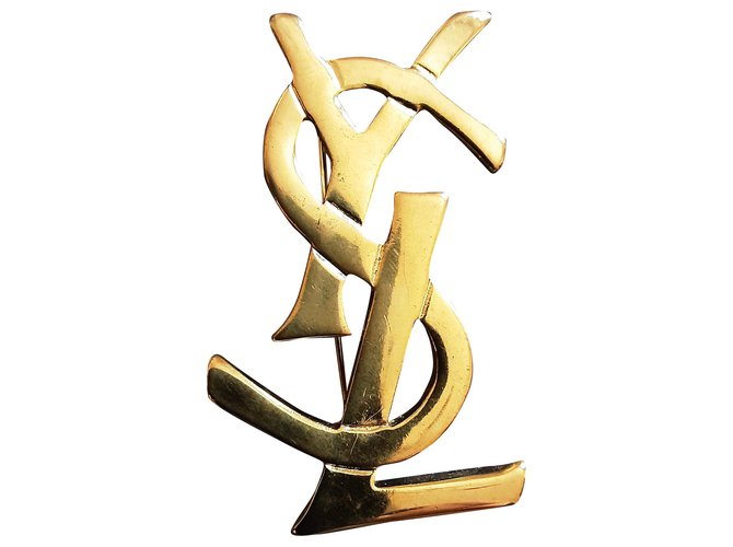 Yves Saint Laurent.  Broche logo. Plaqué or Bijouterie dorée  ref.272591