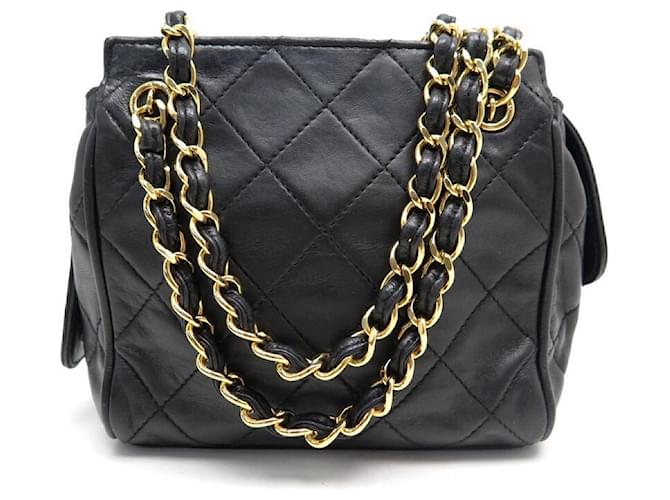 Chanel, Vintage mini black lambskin quilted handbag with gold hardware.