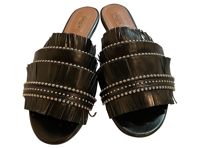 Mules Alaïa con frange in pelle nera Nero