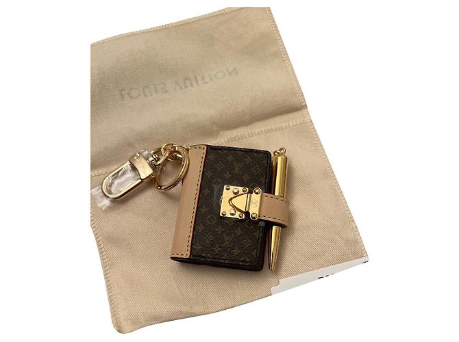 Louis Vuitton portachiavi libro lv Marrone