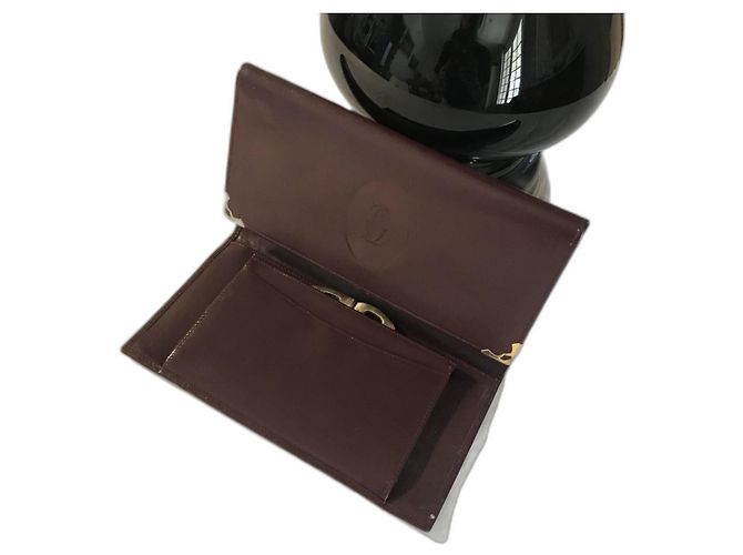 Cartera Cartier Cryptic de piel rojo oscuro Burdeos