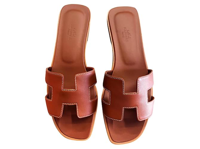 Hermès HERMES Oran gold sandals Brown Leather  ref.886520