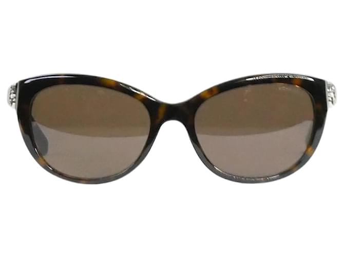 Chanel Brown tortoise shell sunglasses with flower detail at