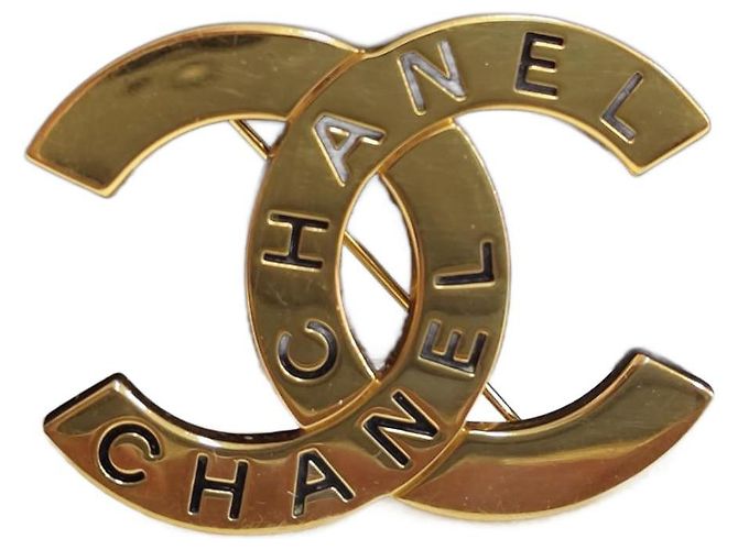 Spilla Chanel CC metallo dorato D'oro