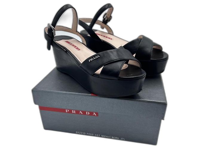 Mulas de cuña Prada en napa negra Negro