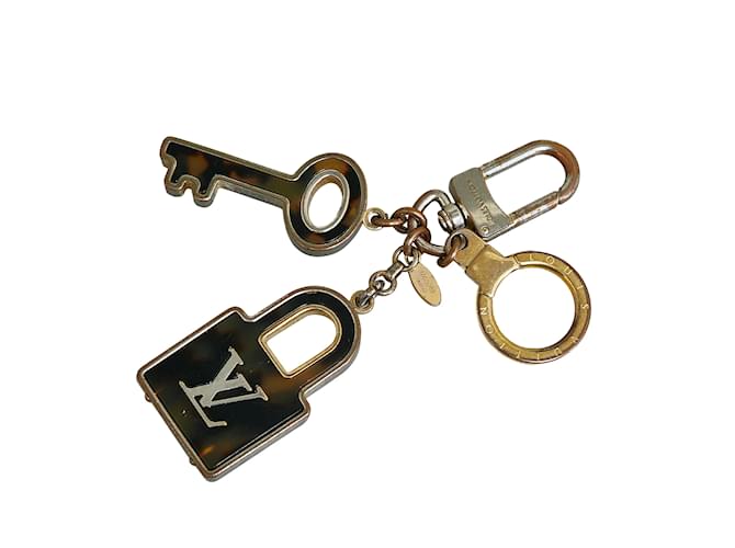 Porta-chaves e pingente de bolsa Louis Vuitton Porte Cles Confidence dourado Sintético  ref.1134404