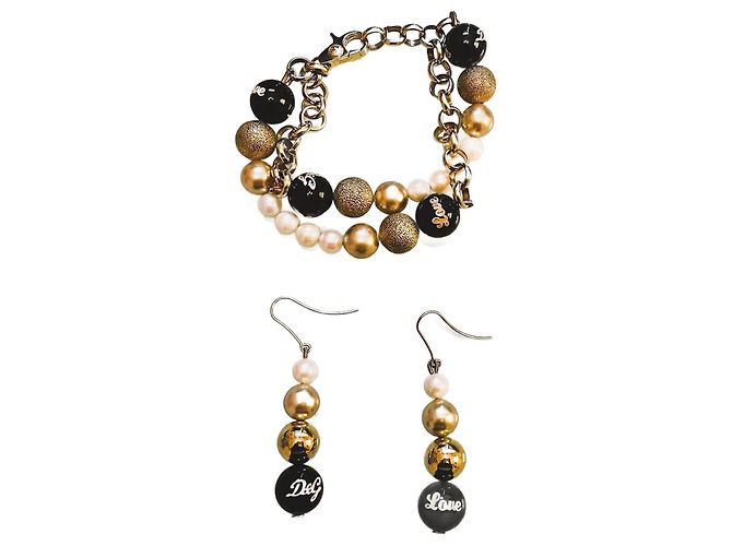 Lindo conjunto luminoso de aço dourado e pérolas, Pulseira e brincos DOLCE & GABBANA com, Pérolas brancas, ouro e preto