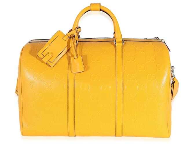 Bolsa de viaje convertible con GG de piel de becerro perforada y grabada en amarillo Gucci Cuero  ref.1216611