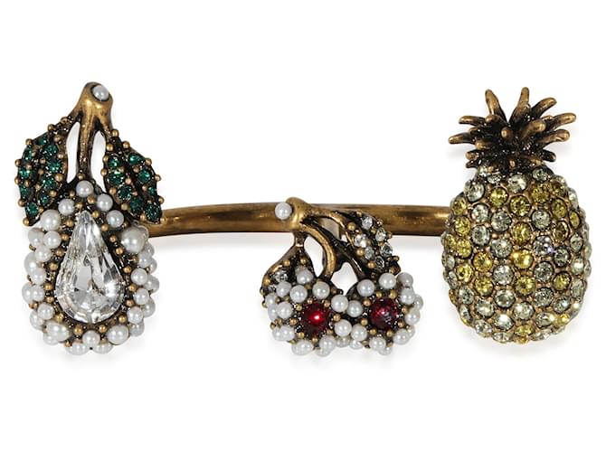 Gucci-Fruchtanhänger aus künstlichen Perlen und Kristallen zwischen dem Fingerring  ref.1220937