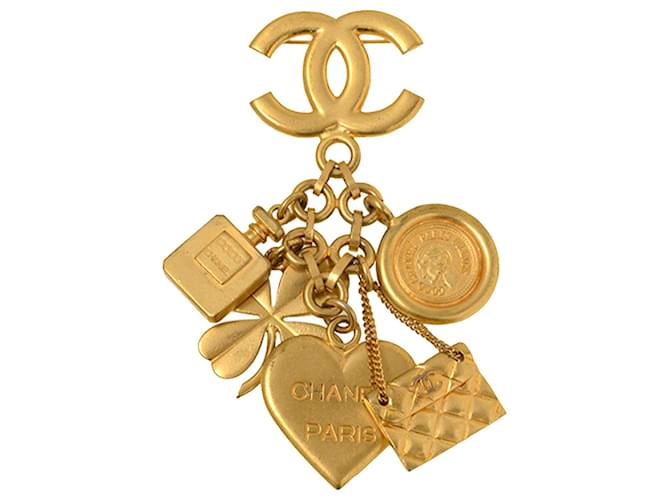 Spilla Chanel con icona in oro e charms D'oro Metallo Placcato in oro  ref.1224257