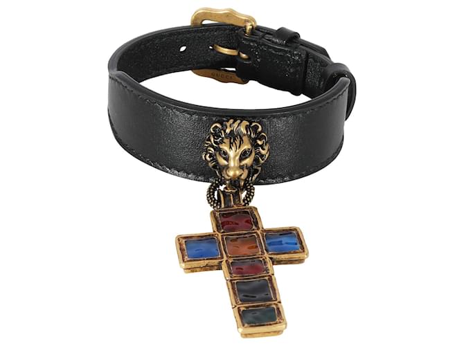 Pulseira dourada Gucci cabeça de leão e joia de couro com cruz tonalizada Metálico  ref.1293340