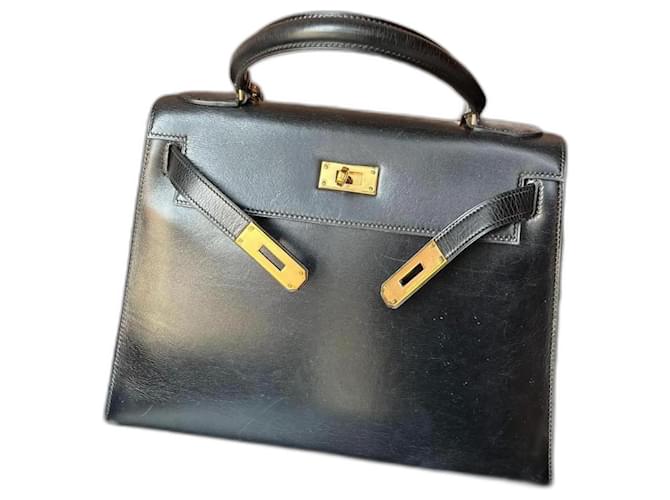 Hermès Kelly 28 en cuir box noir et or  ref.1303170