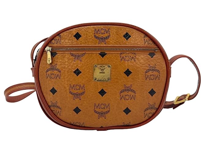 Bolsa transversal vintage MCM, pequena, cor caramelo marrom, com estampa do logo. Conhaque  ref.1318580