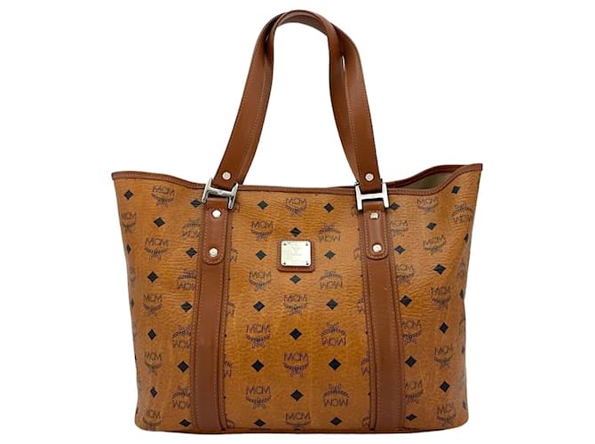 Bolso de compras MCM, bolso bandolera, bolso color coñac marrón con estampado de logo, bolso de mano.  ref.1321459