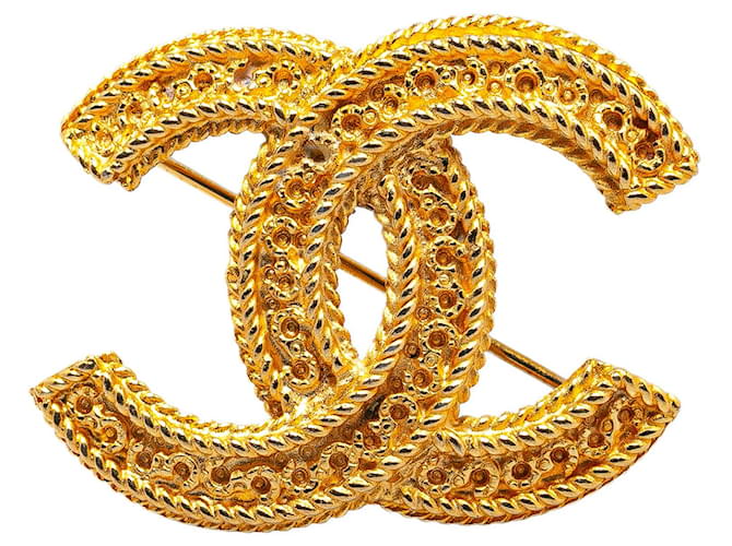 Broche Chanel CC dorée Métal  ref.1390180