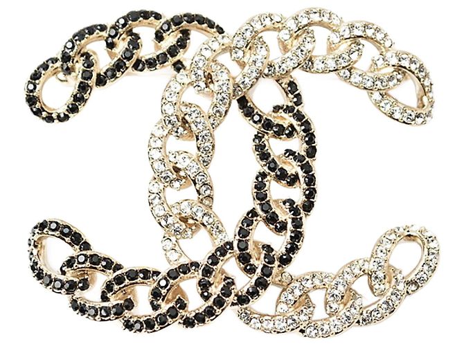 Broche de strass preta e dourada da Chanel Dourado