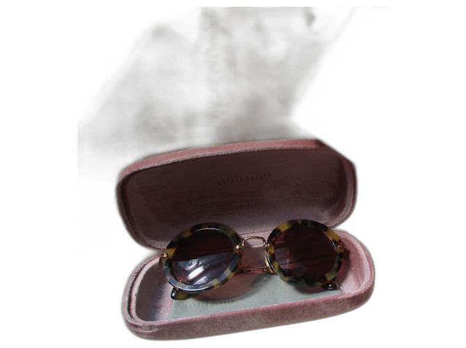 Miu Miu Oversized sunglasses, tortoiseshell effect. Leopard print