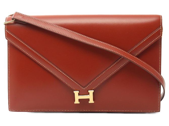 Clutch Lydie em couro box marrom da Hermès